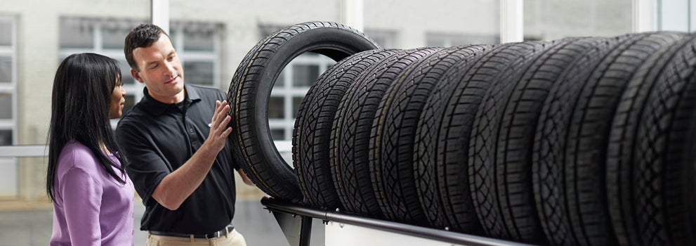 Subaru service representative showing customer a tire. | Open Road Subaru in Union NJ
