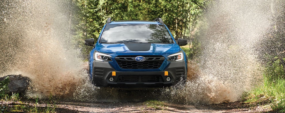 A 2023 Outback Wilderness driving on a muddy trail. | Open Road Subaru in Union NJ